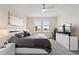 Bedroom with comfortable king bed, ceiling fan, dresser with television and a gaming chair at 8990 Ace Loop, Champions Gate, FL 33896