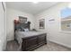 This cozy bedroom has a wooden bed and features sports themed decor at 8990 Ace Loop, Champions Gate, FL 33896