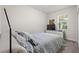 Well-lit bedroom with plush carpeting, neutral color palette, and ample natural light at 8990 Ace Loop, Champions Gate, FL 33896