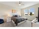 Comfortable bedroom featuring a ceiling fan, two windows and a large king sized bed at 8990 Ace Loop, Champions Gate, FL 33896