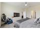 Bedroom featuring a comfy gaming chair, dresser with television and attached bathroom at 8990 Ace Loop, Champions Gate, FL 33896