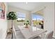 Bright breakfast nook features a marble table with white chairs and sliding door access to a patio at 8990 Ace Loop, Champions Gate, FL 33896