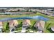 Beautiful homes are closely placed around a picturesque pond, perfect for a serene neighborhood setting at 8990 Ace Loop, Champions Gate, FL 33896