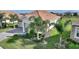 Stunning home featuring lush landscaping, a paver driveway and a tile roof at 8990 Ace Loop, Champions Gate, FL 33896