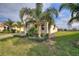 Charming home with stone accents, a paver driveway, and tropical landscaping at 8990 Ace Loop, Champions Gate, FL 33896