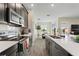 Modern kitchen with stainless steel appliances, dark cabinets, and an open layout at 8990 Ace Loop, Champions Gate, FL 33896