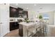 Kitchen with dark cabinetry, stainless steel appliances, a white countertop, and seating at the island at 8990 Ace Loop, Champions Gate, FL 33896