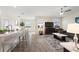 Open-concept living room featuring wood-look tile flooring, recessed lighting, and a ceiling fan at 8990 Ace Loop, Champions Gate, FL 33896