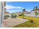 Paver patio with outdoor dining set and lush lawn in this serene backyard setting with privacy fence at 11603 Malverns Loop, Orlando, FL 32832