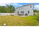 Spacious backyard featuring a well-maintained lawn, patio with a dining set, and mature trees at 11603 Malverns Loop, Orlando, FL 32832