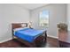 Cozy bedroom with wood flooring, window for natural light, and a comfortable queen-sized bed at 11603 Malverns Loop, Orlando, FL 32832