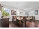 Open-concept dining area showcasing a wooden table and an abundance of natural light from large windows at 11603 Malverns Loop, Orlando, FL 32832