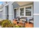 Charming front porch with seating area and tiled floor, perfect for relaxing outdoors at 11603 Malverns Loop, Orlando, FL 32832