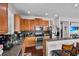 Bright kitchen features stainless steel appliances, wooden cabinets, and granite countertops with a breakfast bar at 11603 Malverns Loop, Orlando, FL 32832
