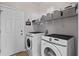 Laundry room featuring a washer, dryer and shelving for storage at 11603 Malverns Loop, Orlando, FL 32832