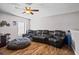 Relaxing living area features a plush leather sofa, wood floors, and neutral walls at 11603 Malverns Loop, Orlando, FL 32832
