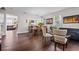 Open-concept living space with hardwood floors, connecting the dining and living areas for easy flow at 11603 Malverns Loop, Orlando, FL 32832