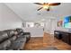 Comfortable living space featuring a large leather sofa, wood floors, and a television at 11603 Malverns Loop, Orlando, FL 32832
