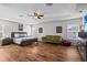 Spacious main bedroom featuring wood floors, a ceiling fan, and many windows for ample natural light at 11603 Malverns Loop, Orlando, FL 32832