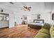 Large main bedroom with wood floors, a ceiling fan, and a comfortable seating area at 11603 Malverns Loop, Orlando, FL 32832