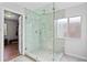 Modern walk-in shower with gray tile and glass enclosure, adjacent to a closet at 11603 Malverns Loop, Orlando, FL 32832