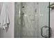 Modern bathroom shower with gray tile and glass door, offering a luxurious showering experience at 11603 Malverns Loop, Orlando, FL 32832