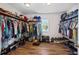 Expansive walk-in closet with ample storage, shelving, and rod space for organizing clothes and shoes at 11603 Malverns Loop, Orlando, FL 32832