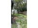 This home features a spacious backyard with mature trees and a wooden fence at 124 Cinnamon Dr, Orlando, FL 32825