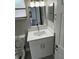 Bright bathroom features modern vanity, white cabinets, and a sleek mirror at 124 Cinnamon Dr, Orlando, FL 32825