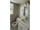 Cozy bathroom with a white vanity, a mirror, a sink, and a toilet, offering a clean and functional space at 124 Cinnamon Dr, Orlando, FL 32825
