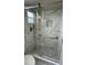Bathroom with walk-in shower, gray and white marbled tiling, and glass door at 124 Cinnamon Dr, Orlando, FL 32825