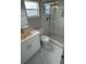 Bathroom featuring a walk-in shower, white marble countertop, and modern fixtures at 124 Cinnamon Dr, Orlando, FL 32825