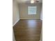 Cozy bedroom with wood flooring, a ceiling fan, and a bright window at 124 Cinnamon Dr, Orlando, FL 32825
