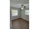 Bright bedroom featuring hardwood floors, two windows letting in natural light, and ceiling fan at 124 Cinnamon Dr, Orlando, FL 32825