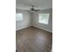 Bedroom featuring wood flooring, a ceiling fan, and bright natural light at 124 Cinnamon Dr, Orlando, FL 32825