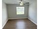 Bright bedroom featuring hardwood floors, ceiling fan, and a window letting in natural light at 124 Cinnamon Dr, Orlando, FL 32825