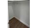 This walk-in closet is spacious, with wood laminate flooring and a hanging rod at 124 Cinnamon Dr, Orlando, FL 32825