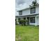 Charming two-story home with a well-maintained lawn and stylish black-framed windows at 124 Cinnamon Dr, Orlando, FL 32825
