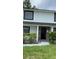 Inviting two-story home with a modern front door and manicured landscaping at 124 Cinnamon Dr, Orlando, FL 32825