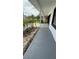 Covered front porch offers curb appeal with neatly landscaped garden beds at 124 Cinnamon Dr, Orlando, FL 32825