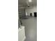 Spacious garage with a roll-up door, painted floors and ample space for parking and storage at 124 Cinnamon Dr, Orlando, FL 32825