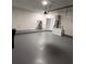 Spacious garage with water heater features a modern, minimalist aesthetic at 124 Cinnamon Dr, Orlando, FL 32825