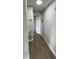 Hallway with wood flooring, white trim, and neutral walls exudes simple elegance at 124 Cinnamon Dr, Orlando, FL 32825