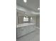 Kitchen island features a quartz countertop and white cabinets at 124 Cinnamon Dr, Orlando, FL 32825