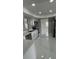 Modern kitchen featuring stainless steel appliances, white cabinets, and a stylish tiled floor at 124 Cinnamon Dr, Orlando, FL 32825
