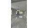 Spacious living room with neutral paint, contemporary chandelier and large tile flooring at 124 Cinnamon Dr, Orlando, FL 32825