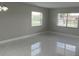 Bright living room with large windows offering ample natural light and tiled floors adding modern touch at 124 Cinnamon Dr, Orlando, FL 32825