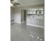 Open concept living room featuring white marble flooring and a view into the updated kitchen at 124 Cinnamon Dr, Orlando, FL 32825