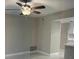 Neutral living room featuring a ceiling fan, tile floors, and access to the kitchen at 124 Cinnamon Dr, Orlando, FL 32825