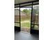View of a covered patio with access to the backyard and fence, enclosed with a screen at 124 Cinnamon Dr, Orlando, FL 32825